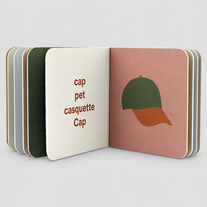 Open Trixie Clothing board book with cap illustration and multilingual words, toddler book UAE