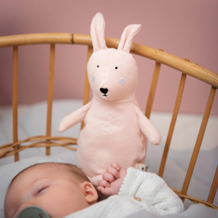Trixie Rabbit soft toy beside sleeping newborn baby in a nursery, baby gift UAE