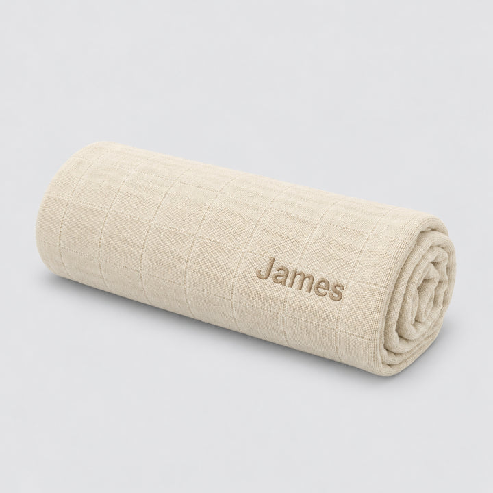 Personalised beige Trixie muslin swaddle with James embroidered, baby gift UAE