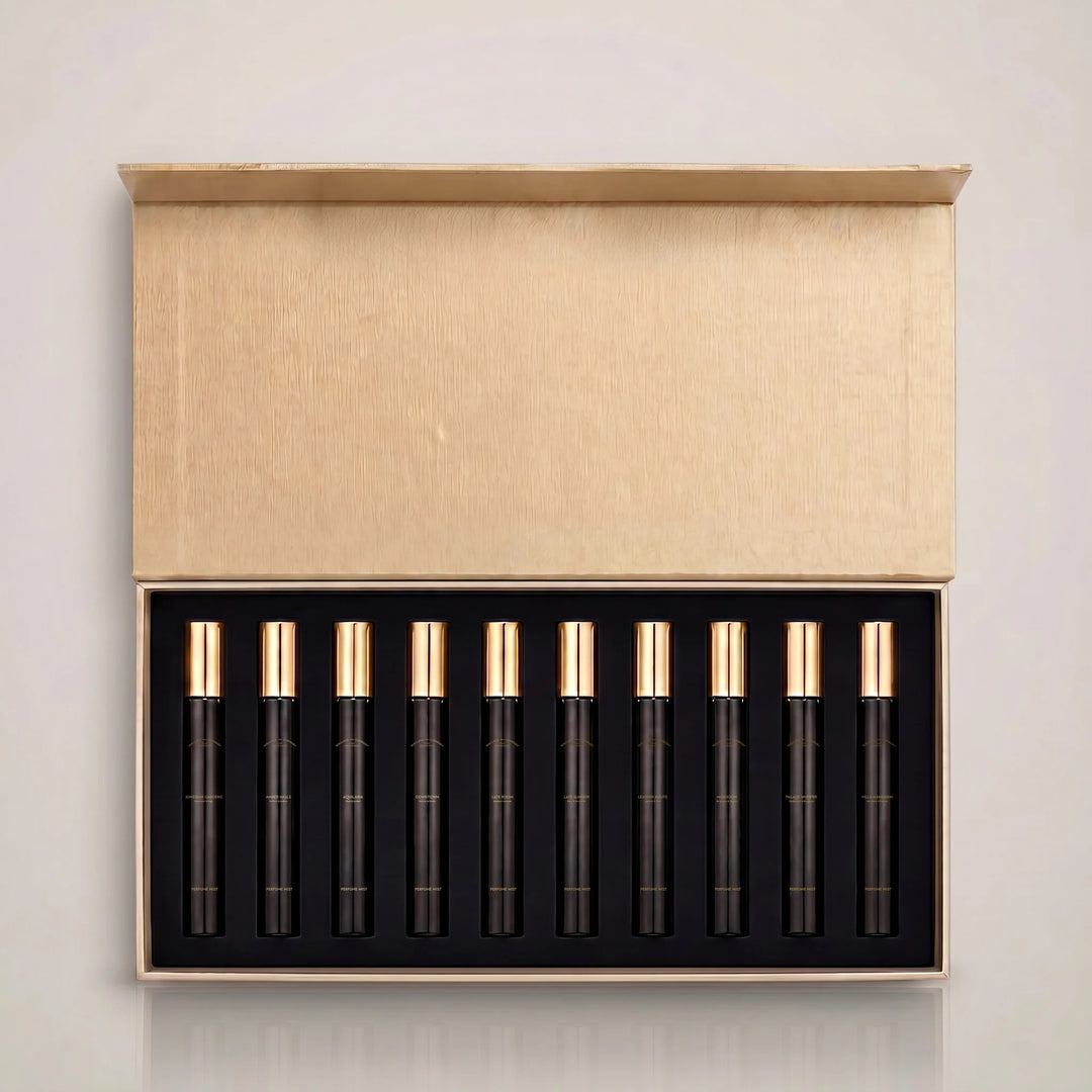 Wallace & Company Discovery Set featuring 10 perfume mist samples in black vials with gold caps, presented in an open beige gift box.