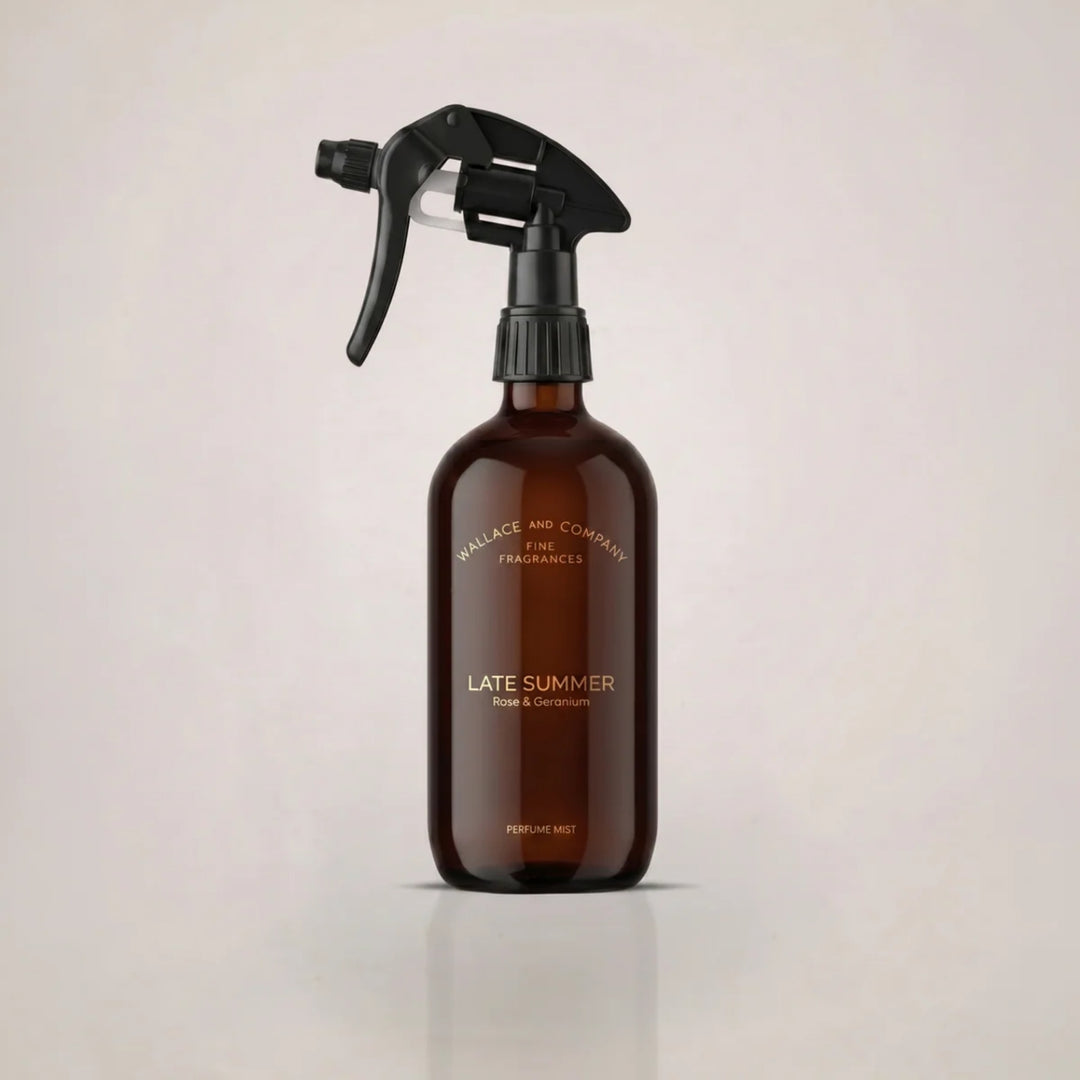 Wallace & Company Late Summer Rose & Geranium Perfume Mist in an amber glass spray bottle with a black trigger.