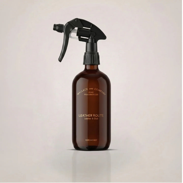 Wallace & Company Leather Route Leather & Oud Perfume Mist in an amber glass spray bottle with a black trigger.