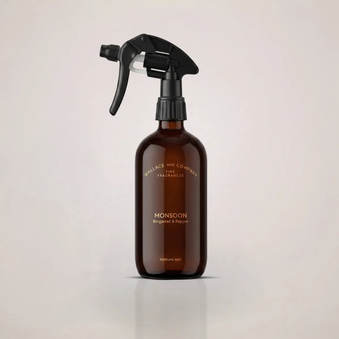 Wallace & Company Monsoon Bergamot & Pepper Perfume Mist in an amber glass spray bottle with a black trigger.