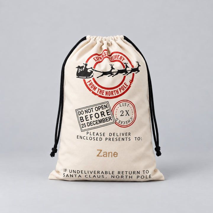 Personalised cream Christmas drawstring sack with Santa sleigh, reindeer and North Pole express delivery design, finished with the name “Zane”.