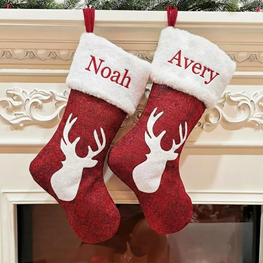 Two red Christmas stockings with white fur trim and reindeer designs, personalized with 'Noah' and 'Avery', hanging on a decorative fireplace mantle.
